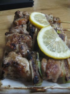 Cooked chicken skewers and lemon